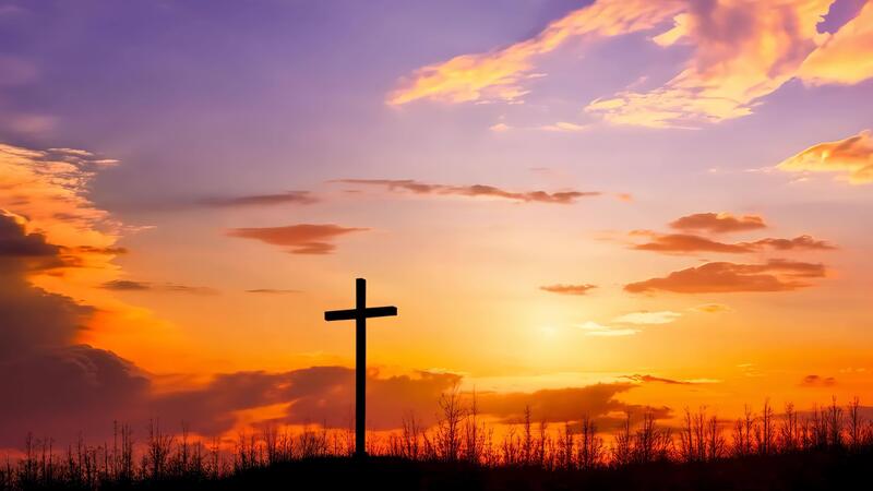 Cross with golden sunset sky symbolizing hope and faith